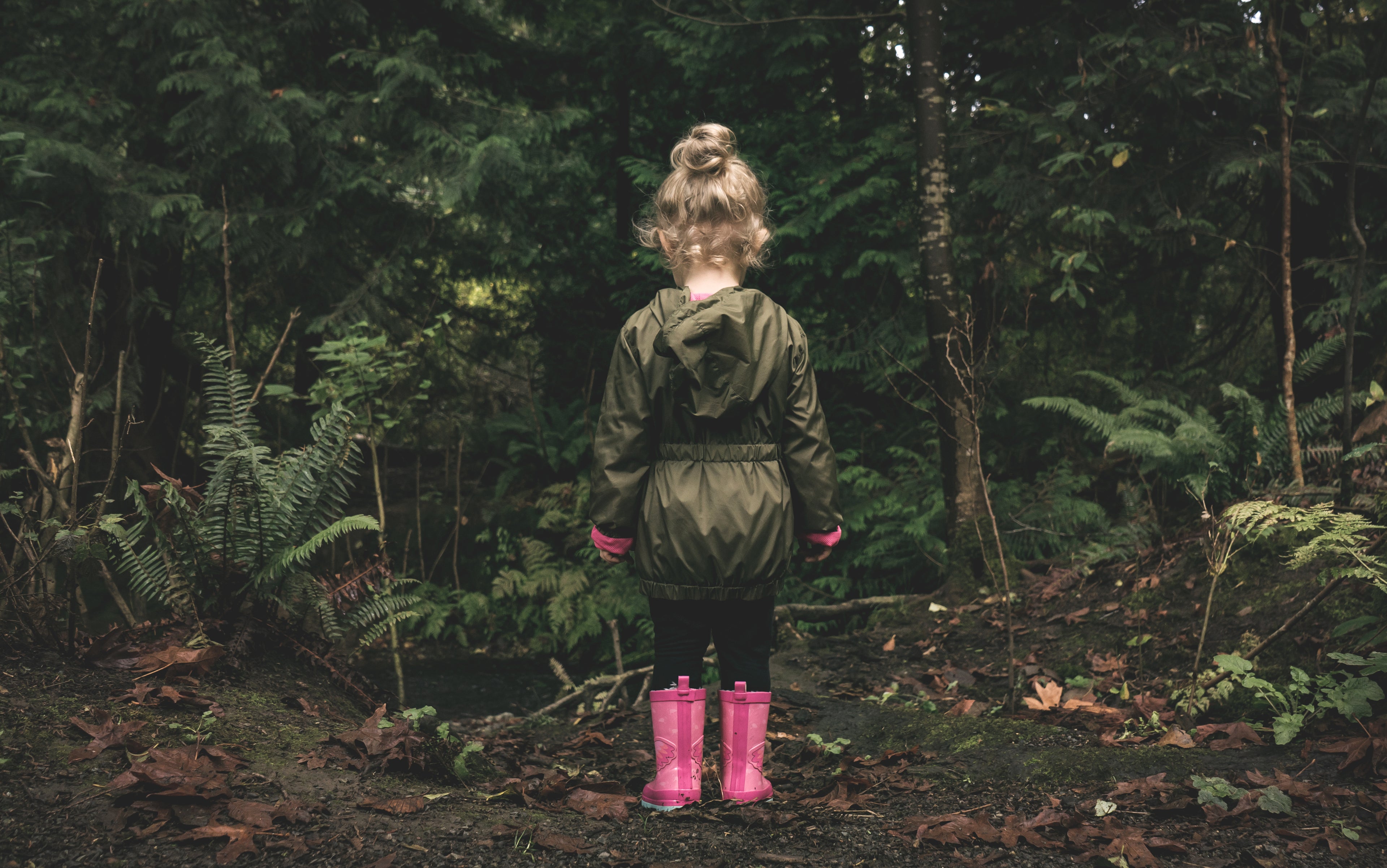 A young person walking in an all natural environment